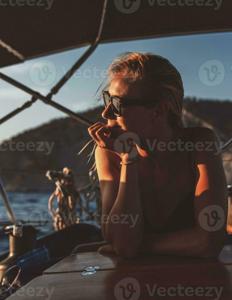 Attractive woman on the sailboat photo