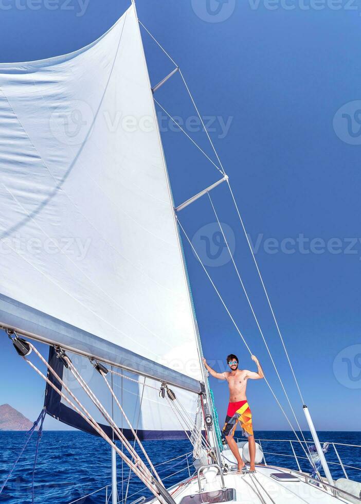 Cheerful man on sailboat photo