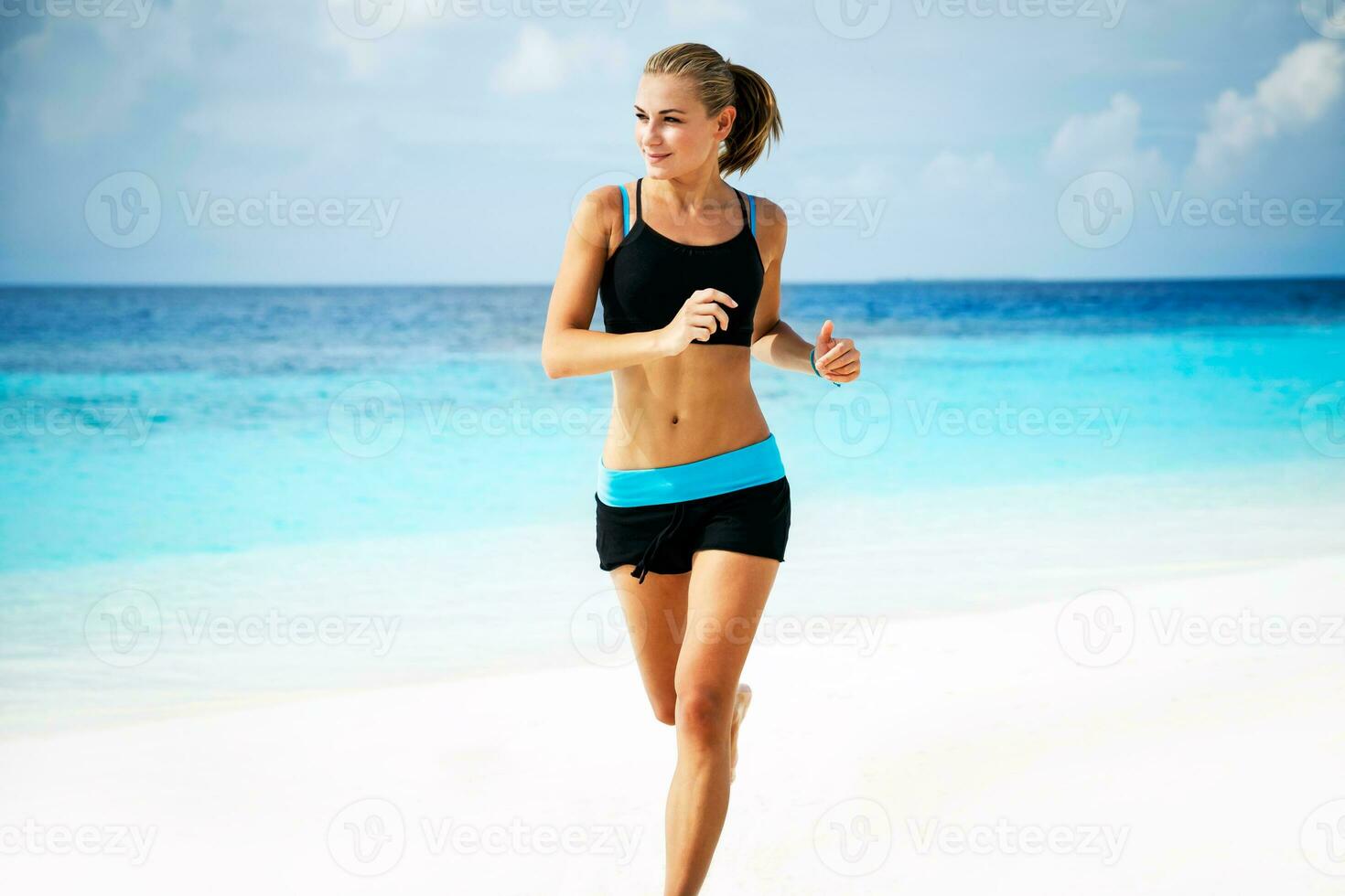 Woman running on the beach photo