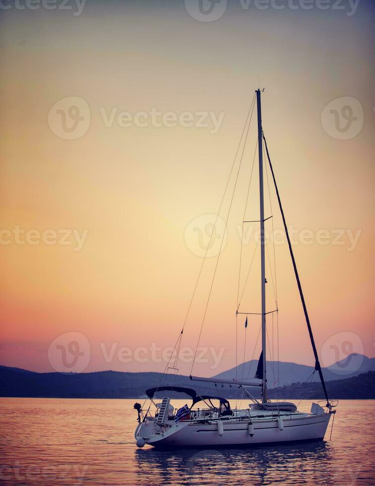 Sailboat in sunset light photo