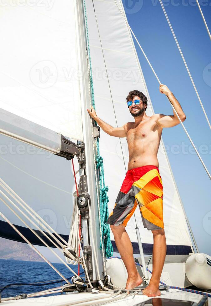 Happy man on sailboat photo