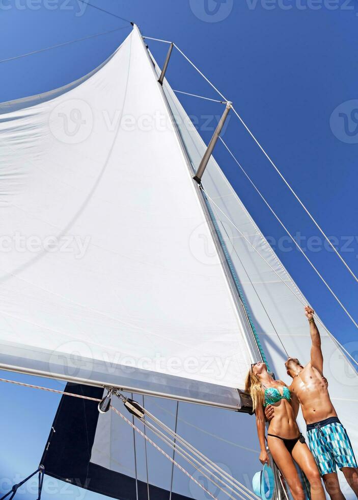 Happy couple on sailboat photo