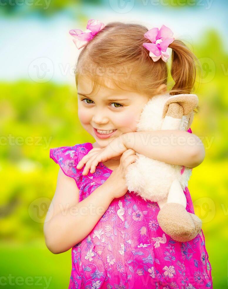 Baby girl with soft toy photo