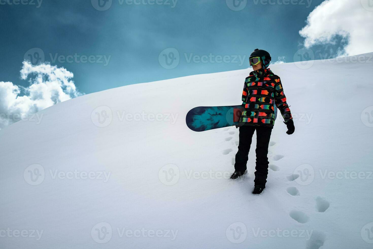 Girl snowboarder enjoys winter sport photo