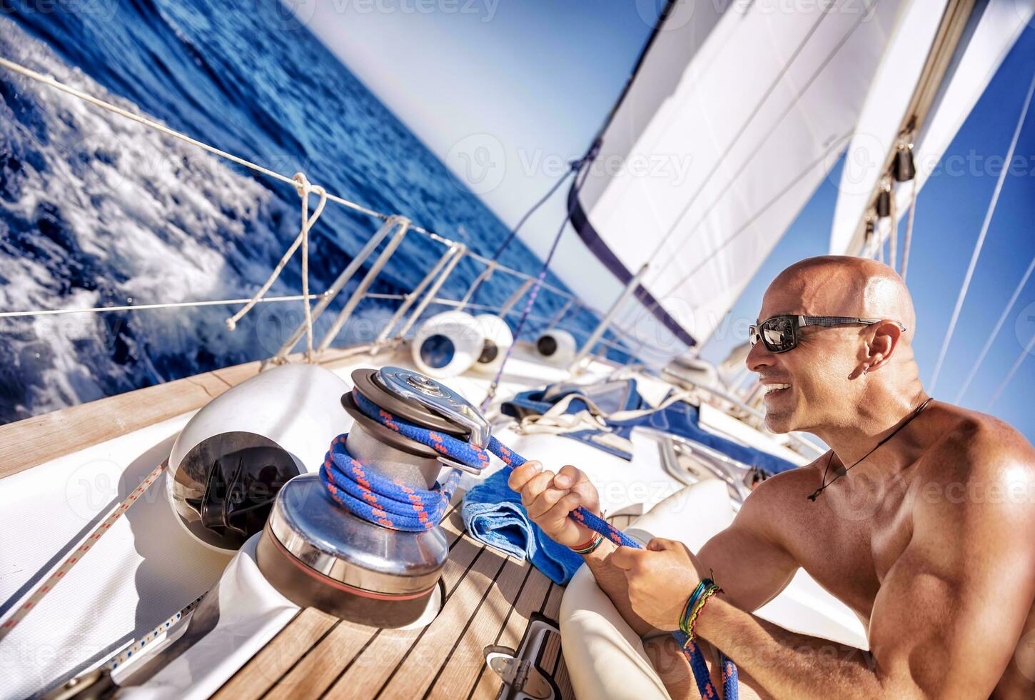 Handsome strong man working on sailboat photo