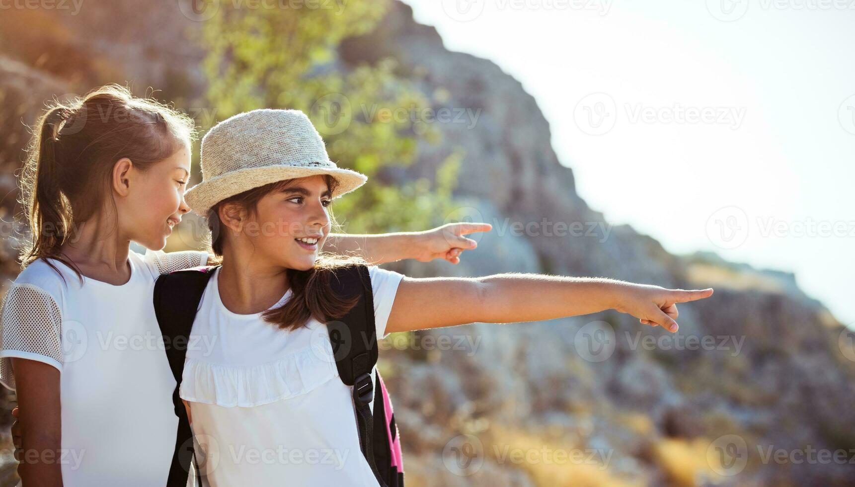 Two girls enjoying walking tour to mountains photo