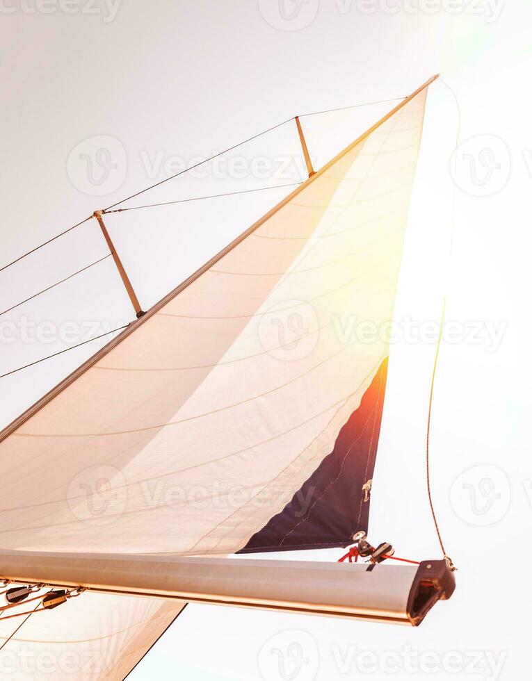 Sail over sunset sky photo