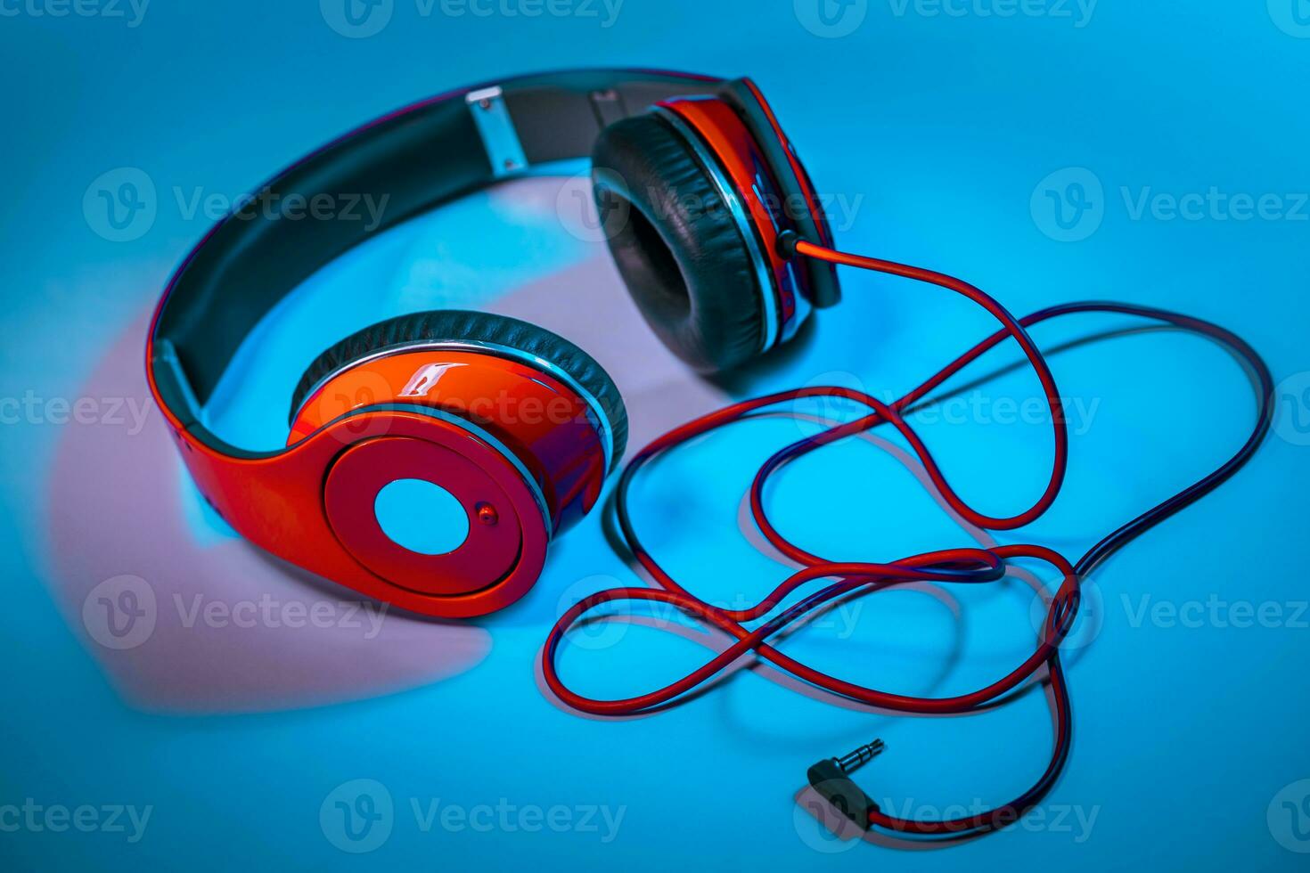 Red Headphones on Blue Background photo