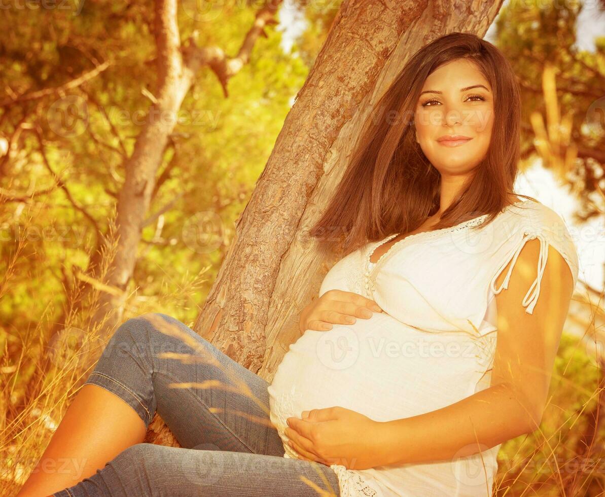 Expectant woman outdoors photo