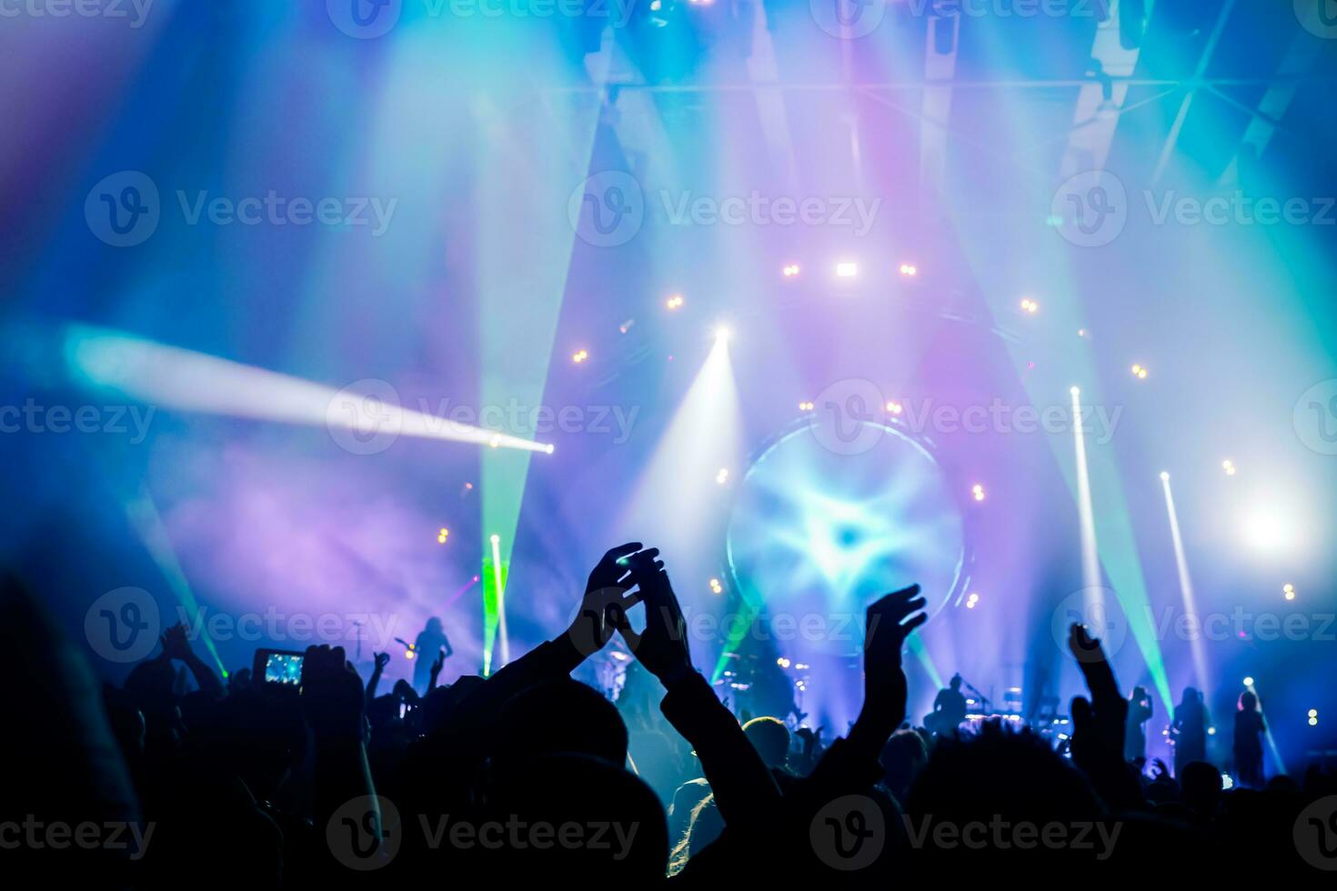 Concert background with dancing crowd photo