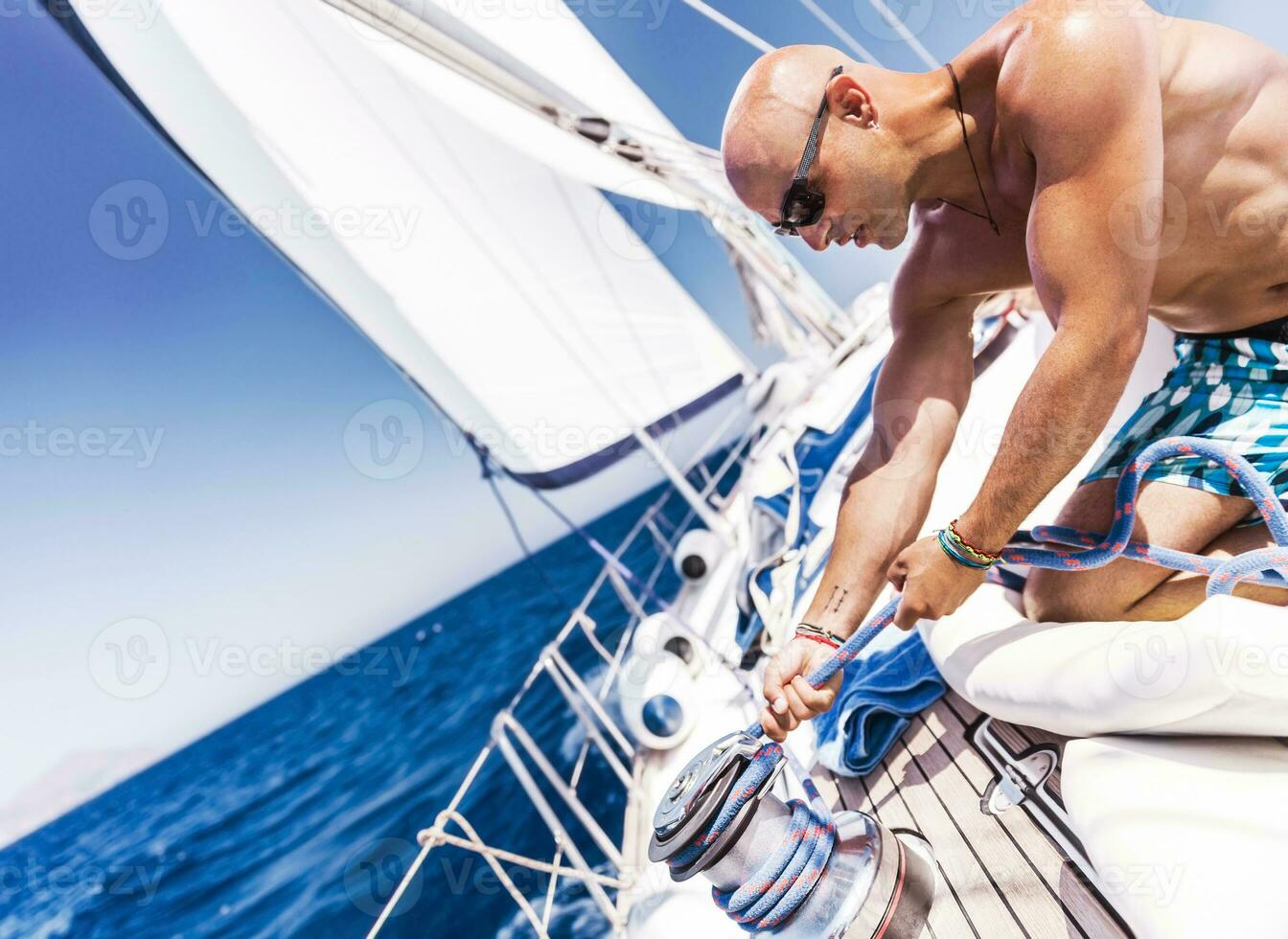 Handsome sailor on sailboat photo