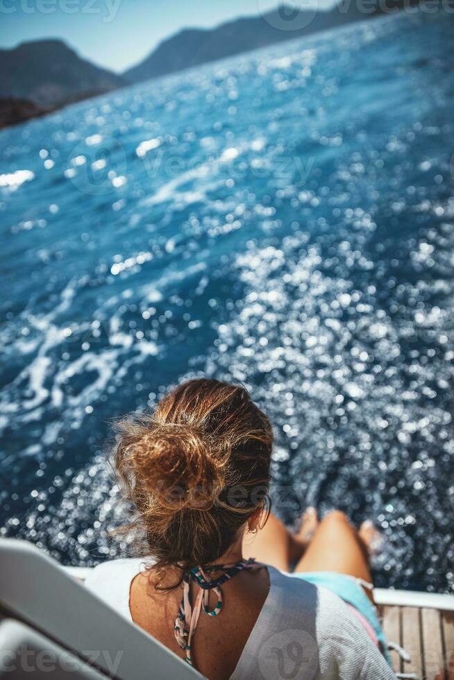 Woman enjoys time on sailboat photo