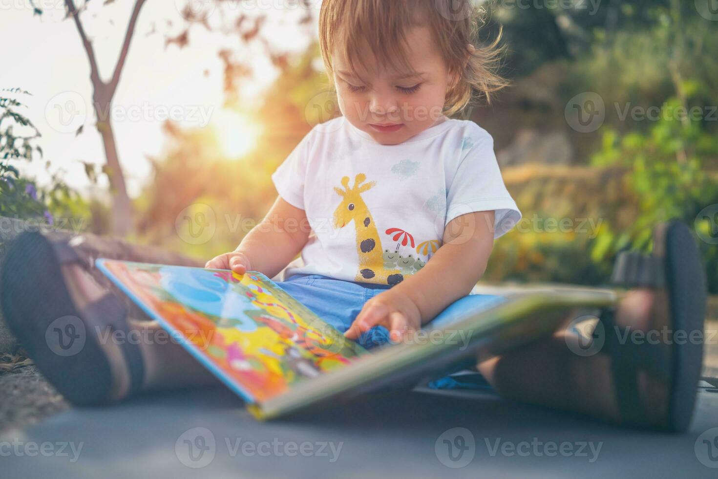 Little Boy with Book Outdoors photo