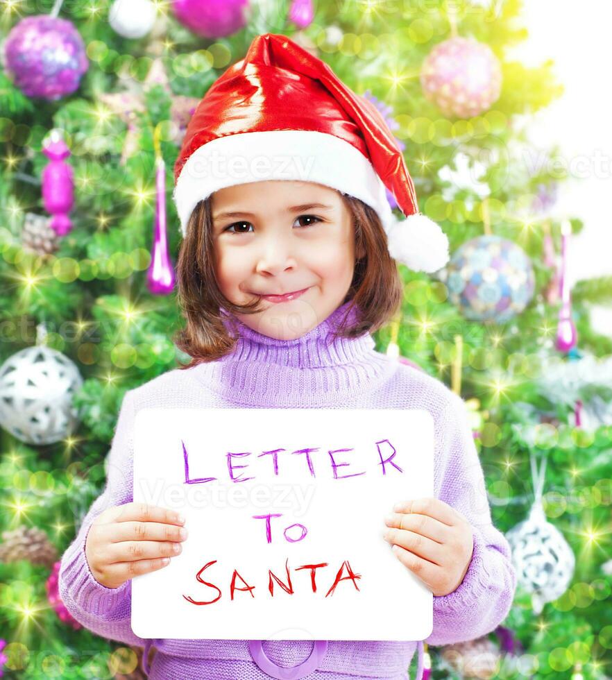 Little girl with letter to Santa Claus photo