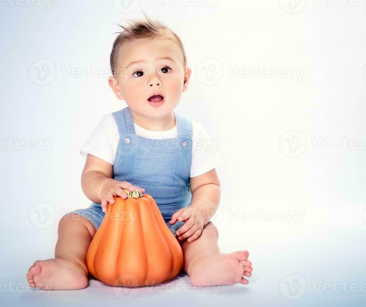 Happy boy with Thanksgiving pumpkin photo