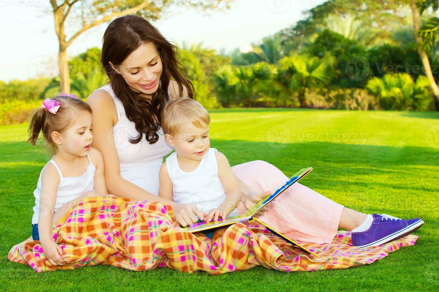 Mother with children read book photo