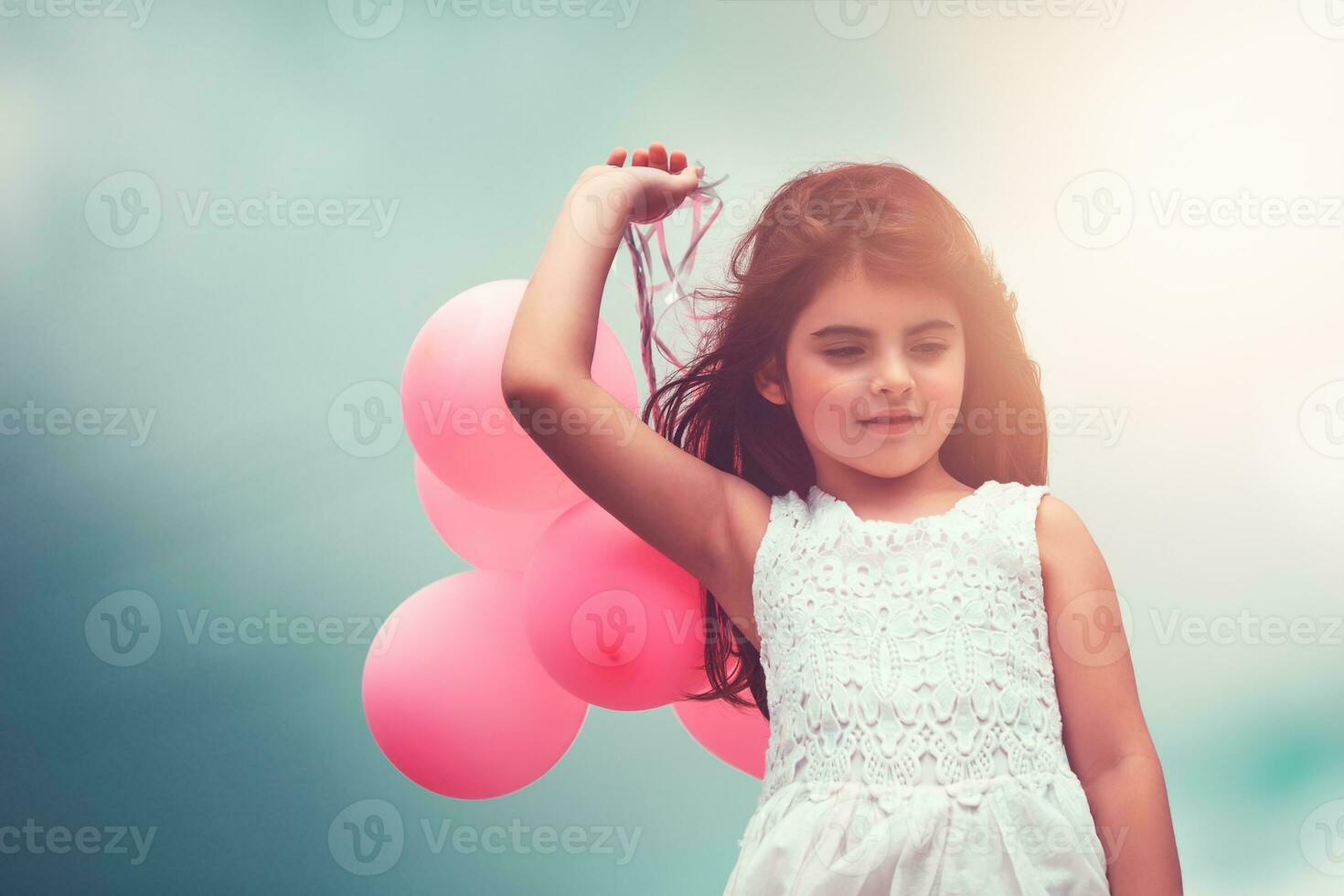 Happy girl with air balloons photo