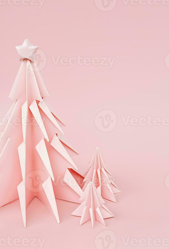 Pink origami Christmas trees. Monochrome winter holidays background. photo