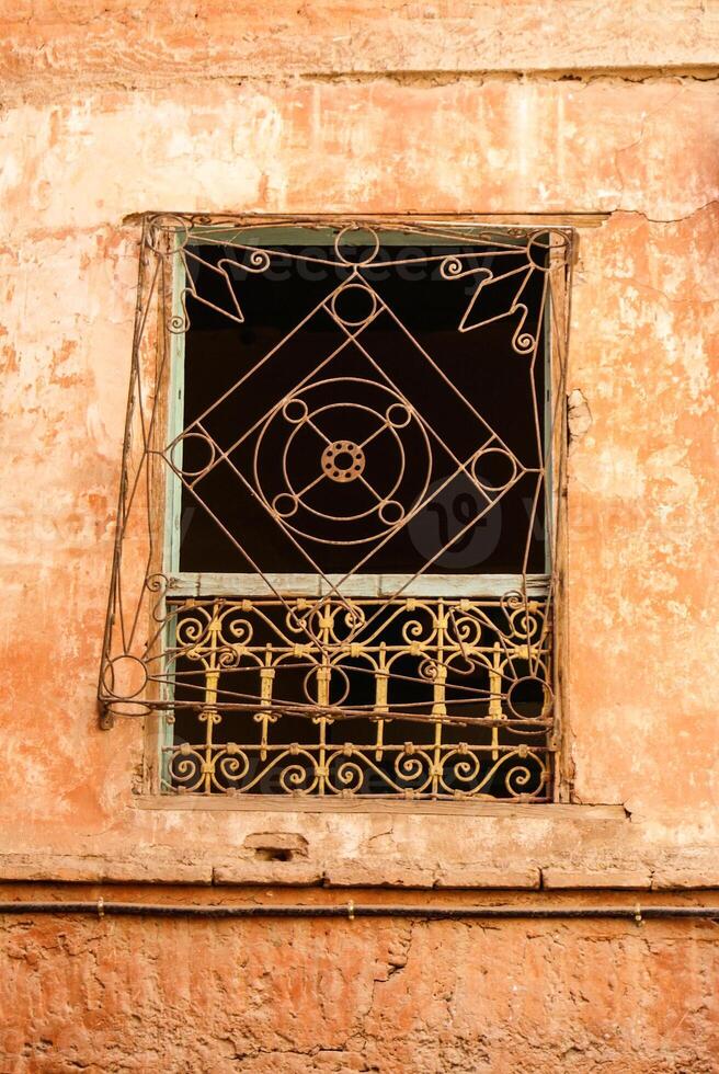 Morocco Ouarzazate - Arabesque window in the medieval Kasbah built in adobe photo