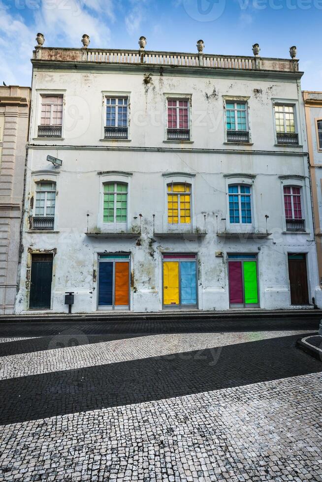 Facade of the old Portuguese houses with colorful doors and windows. photo