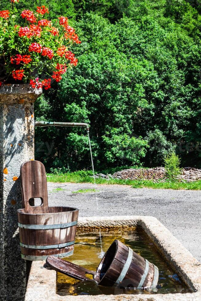 old well and wooden bucket photo