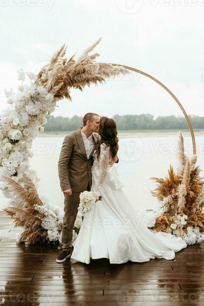 wedding ceremony of the newlyweds on the pier photo