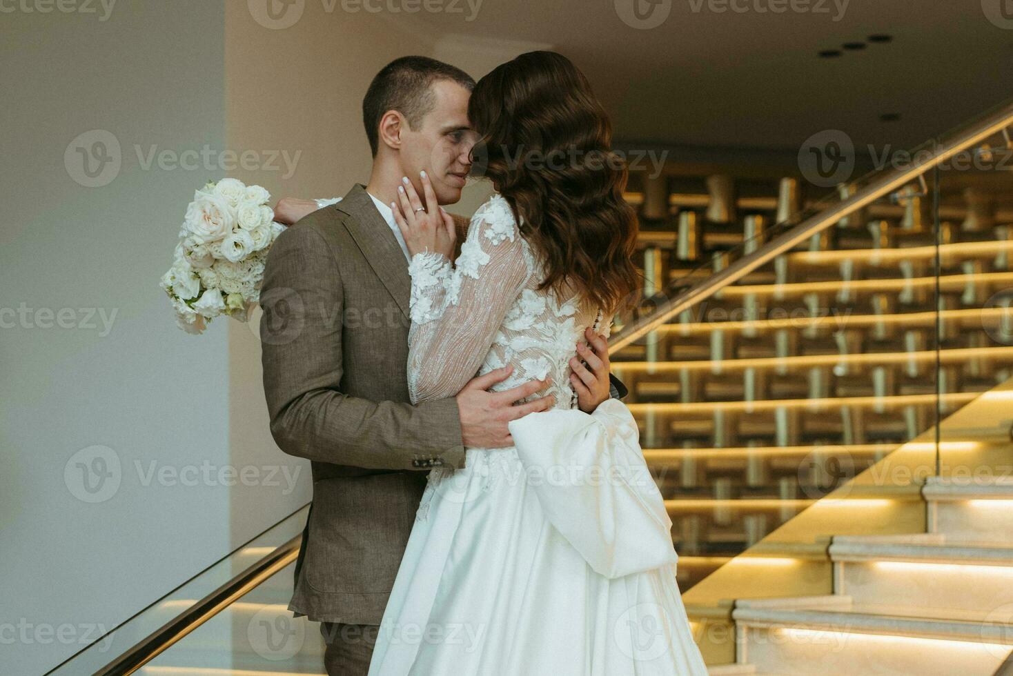 meeting of the bride and groom on the hotel stairs photo