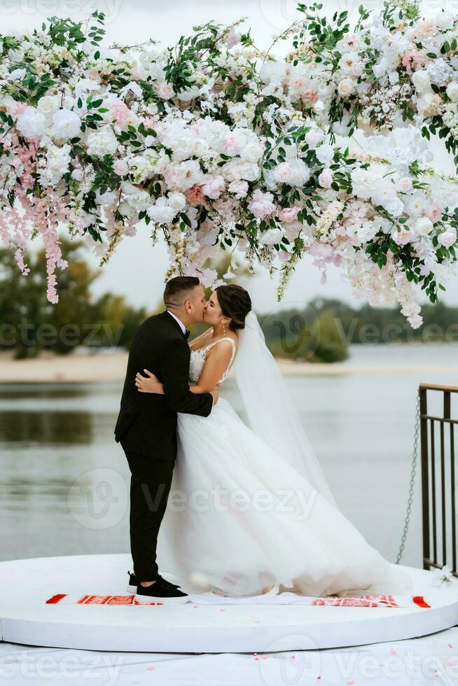 wedding ceremony of the newlyweds on the pier photo