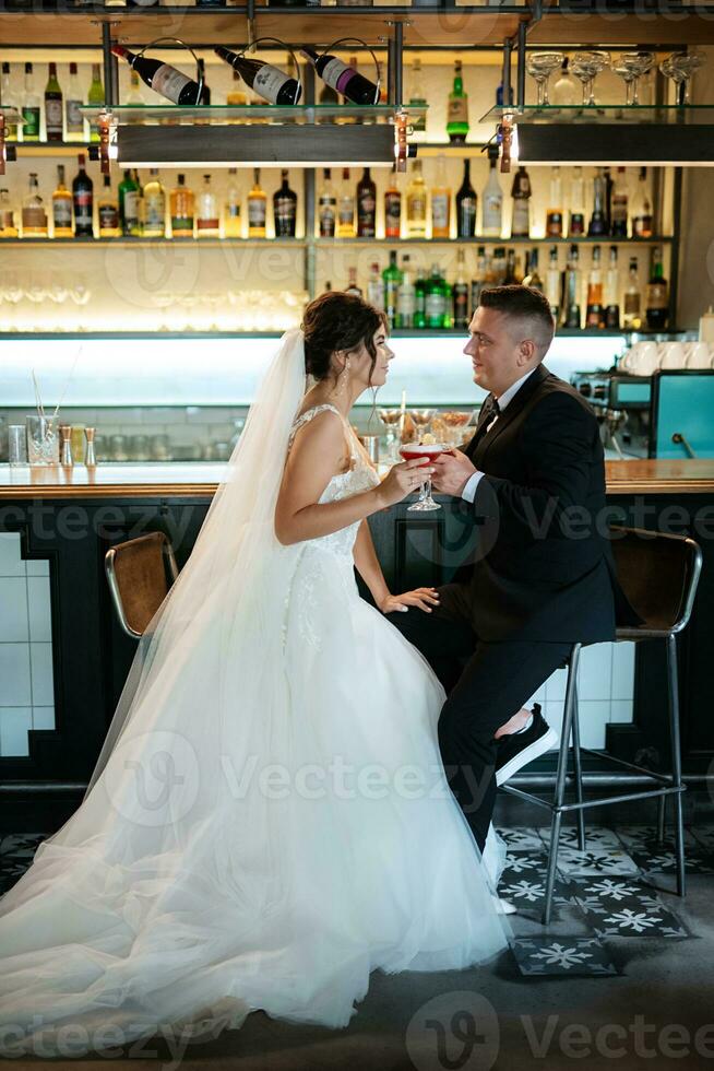 bride and groom inside a cocktail bar photo