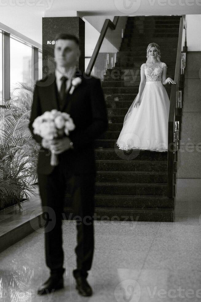 meeting of the bride and groom in the hotel lobby photo