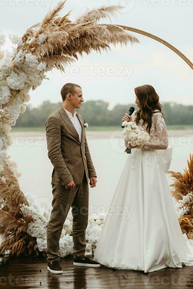 wedding ceremony of the newlyweds on the pier photo