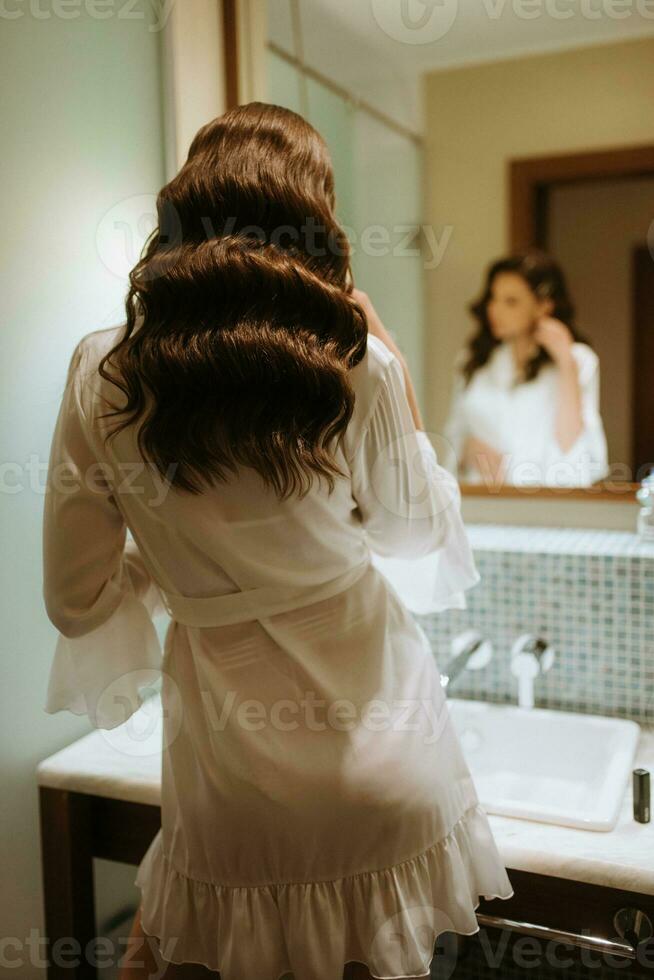 brown-haired girl in the morning in the bathroom photo