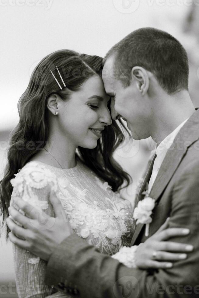 the first wedding dance of the bride and groom on the pier near the river photo