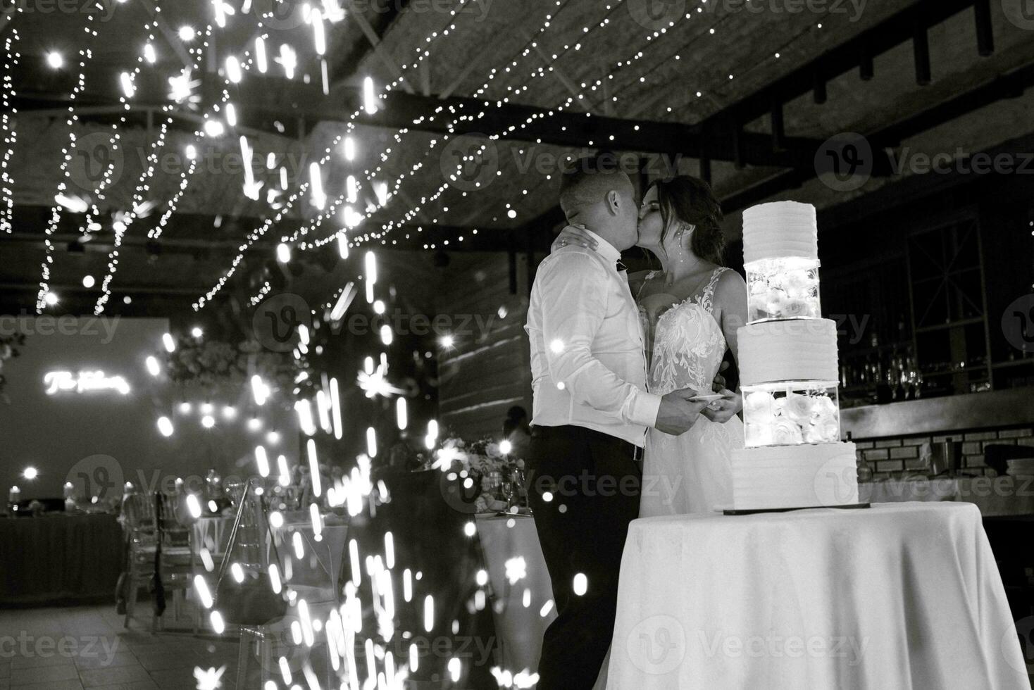 newlyweds happily cut and taste the wedding cake photo