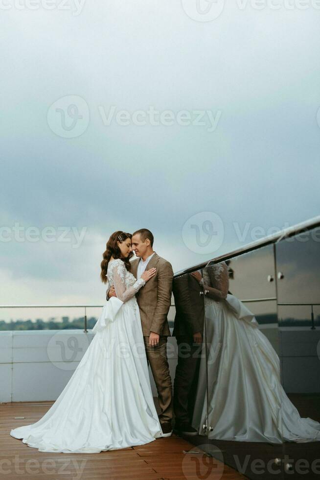 bride and groom first meeting on the roof of skyscraper photo