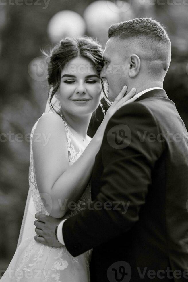 the groom in a brown suit and the bride in a white dress photo