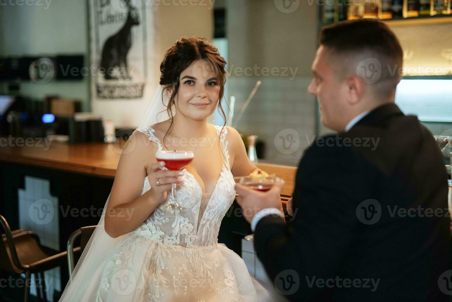 bride and groom inside a cocktail bar photo