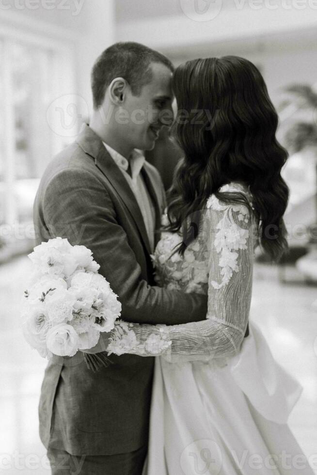 meeting of the bride and groom on the hotel stairs photo