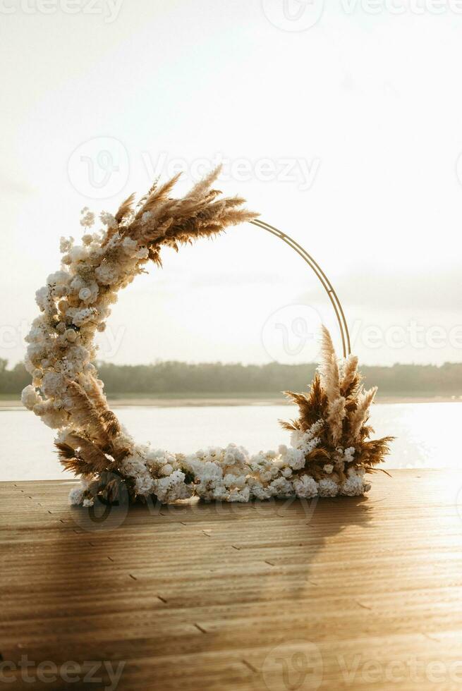 wedding round arch against the background of a river photo