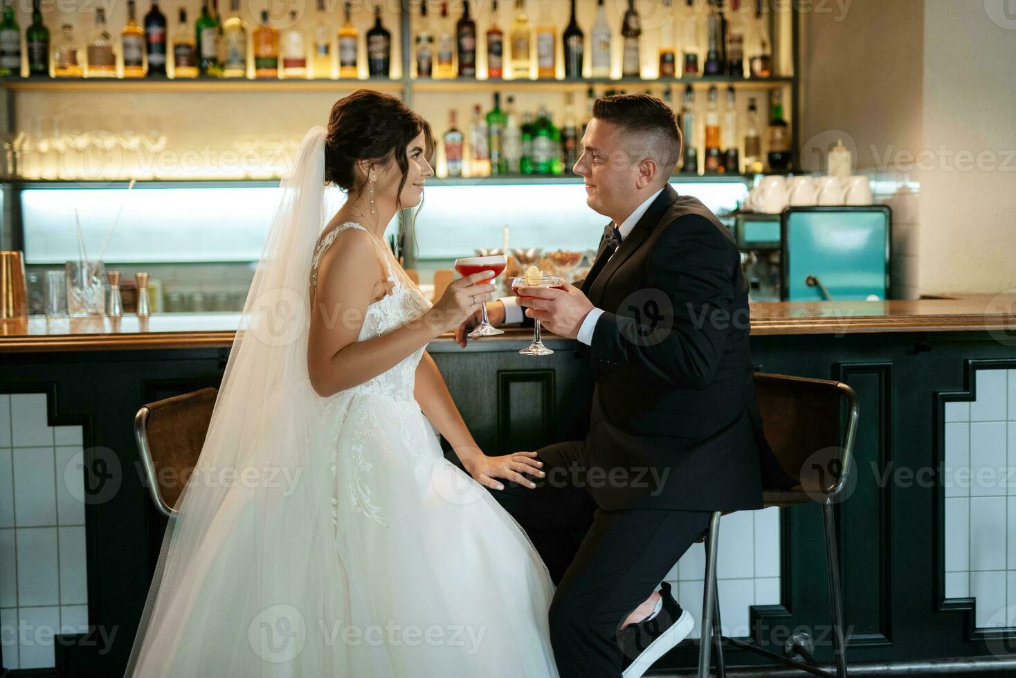 bride and groom inside a cocktail bar photo