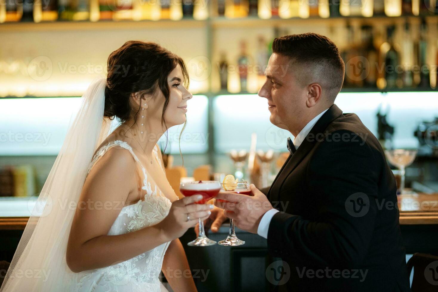 bride and groom inside a cocktail bar photo