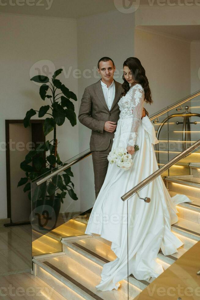 meeting of the bride and groom on the hotel stairs photo