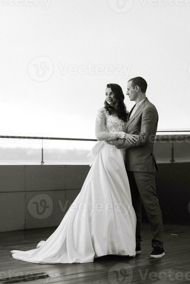 bride and groom first meeting on the roof of skyscraper photo