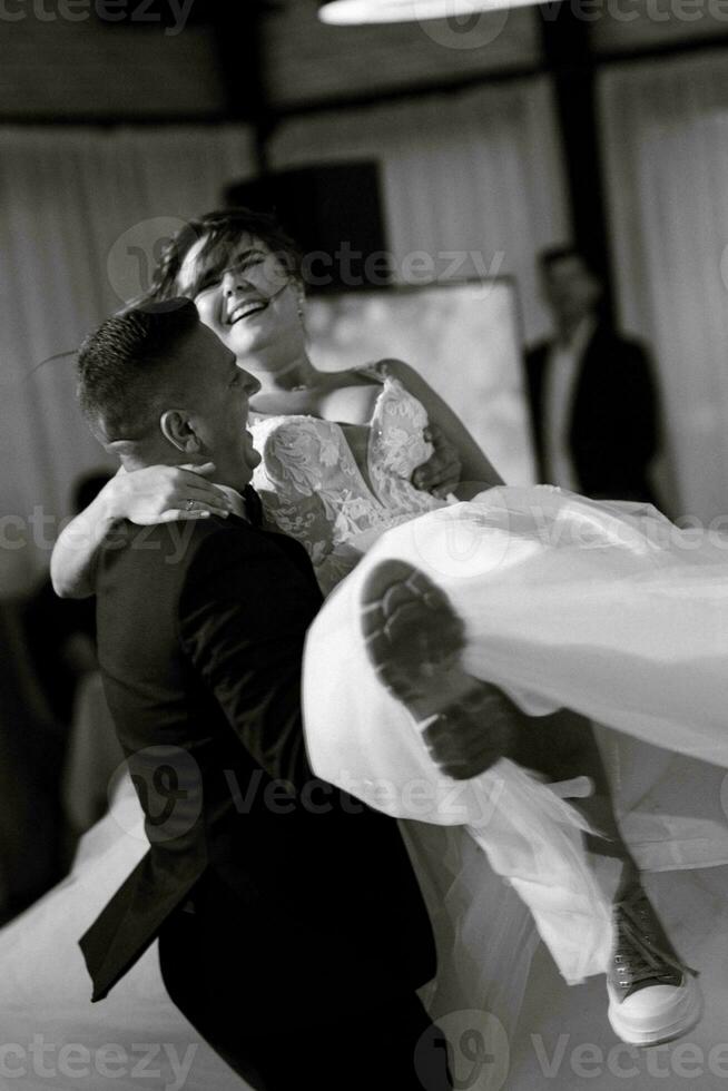 the first dance of the bride and groom inside a restaurant photo