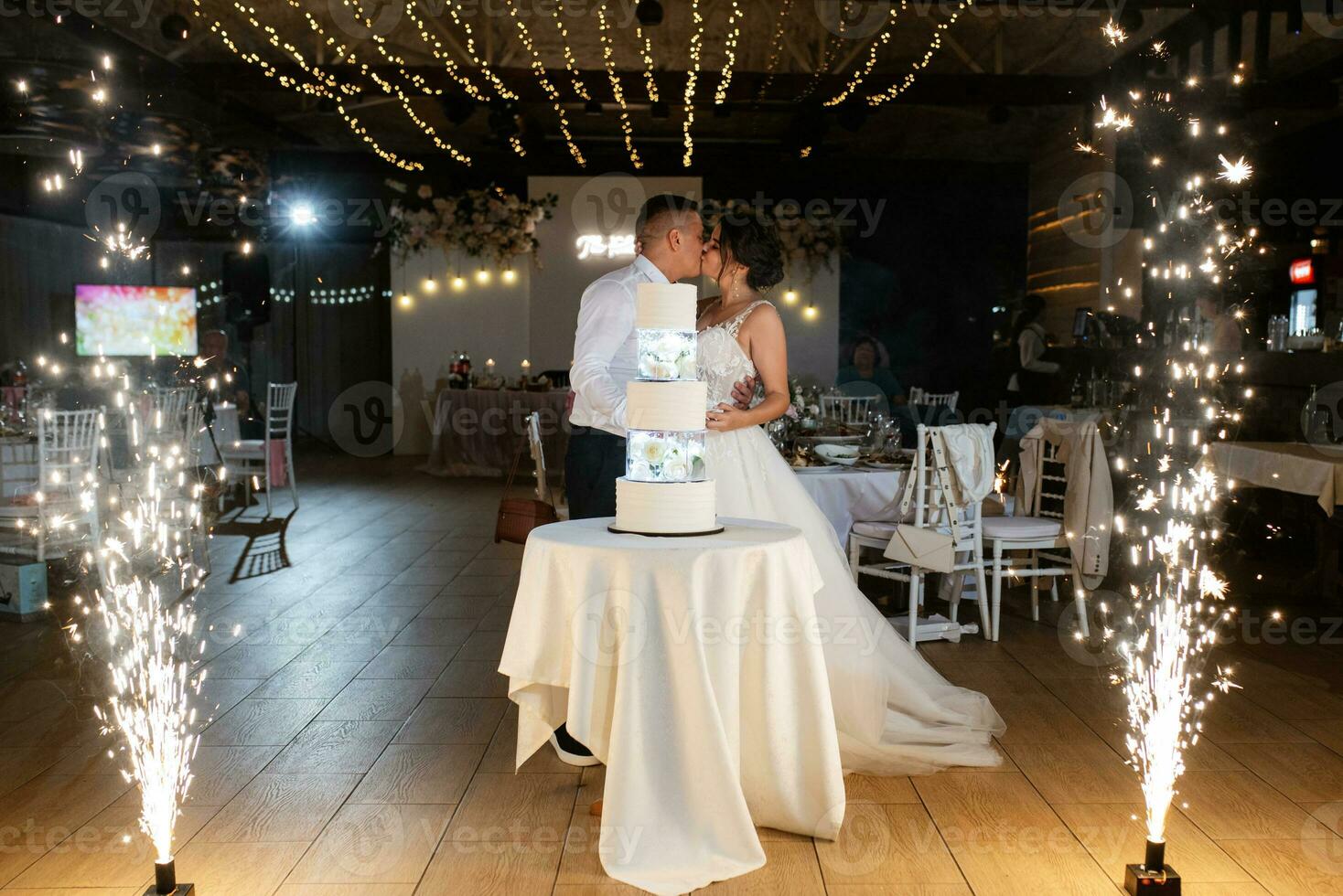 newlyweds happily cut and taste the wedding cake photo