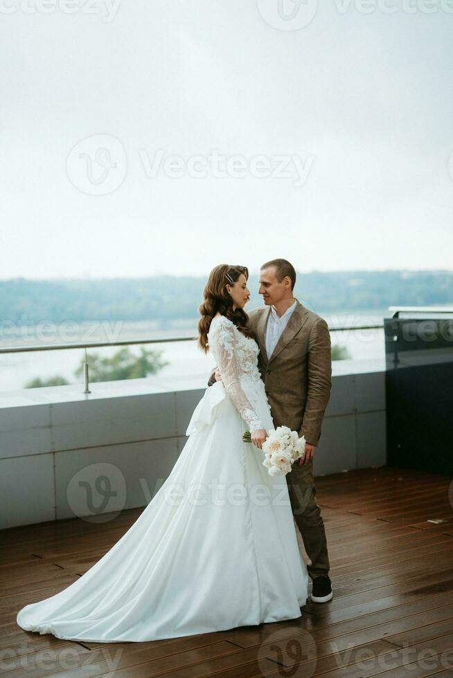 bride and groom first meeting on the roof of skyscraper photo