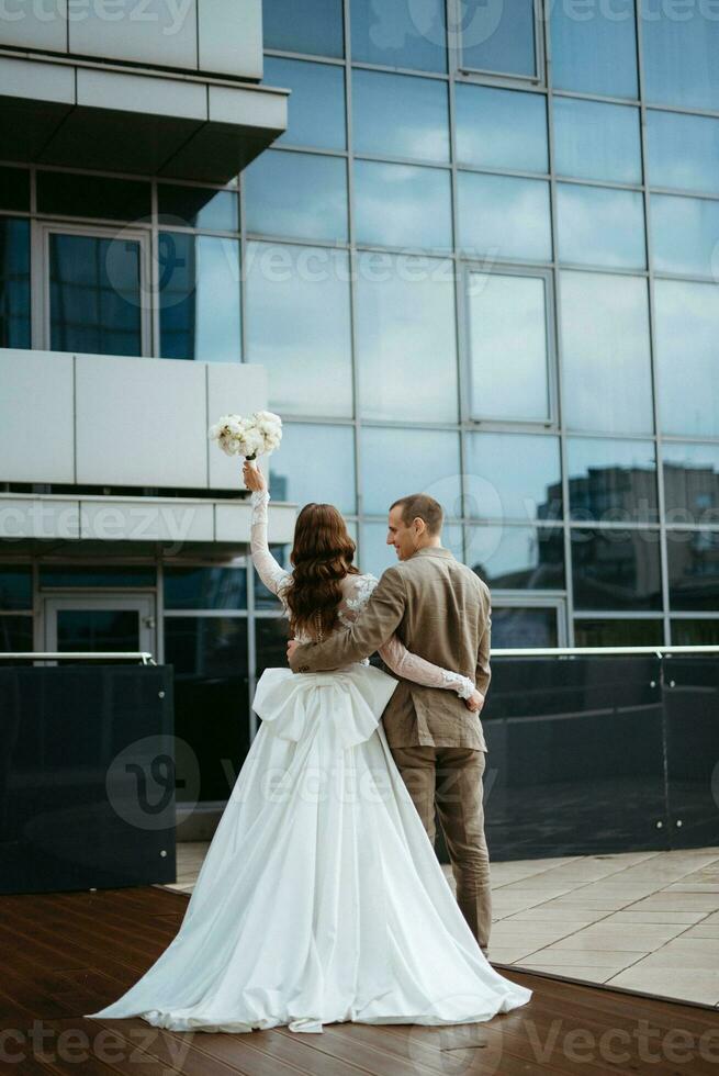 bride and groom first meeting on the roof of skyscraper photo