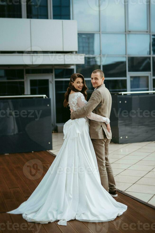 bride and groom first meeting on the roof of skyscraper photo