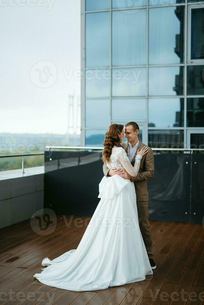 bride and groom first meeting on the roof of skyscraper photo