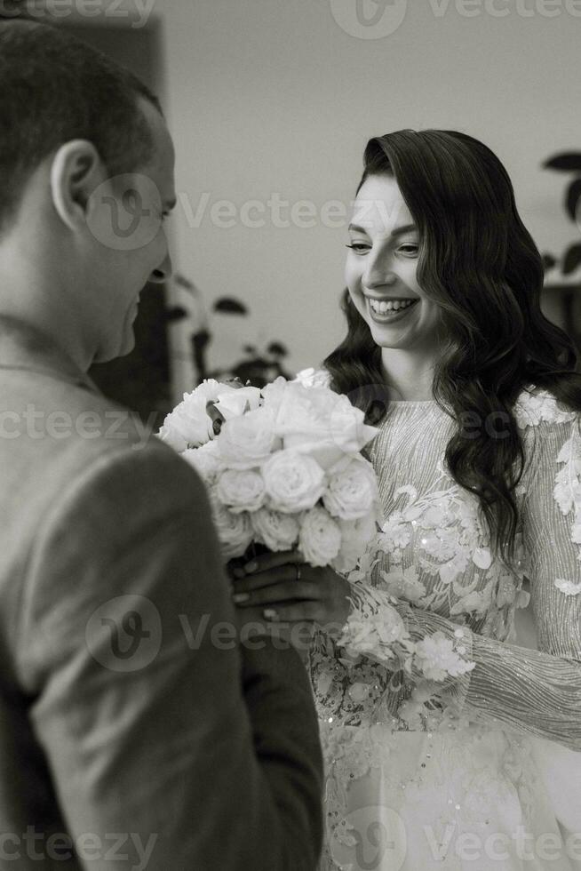 meeting of the bride and groom on the hotel stairs photo